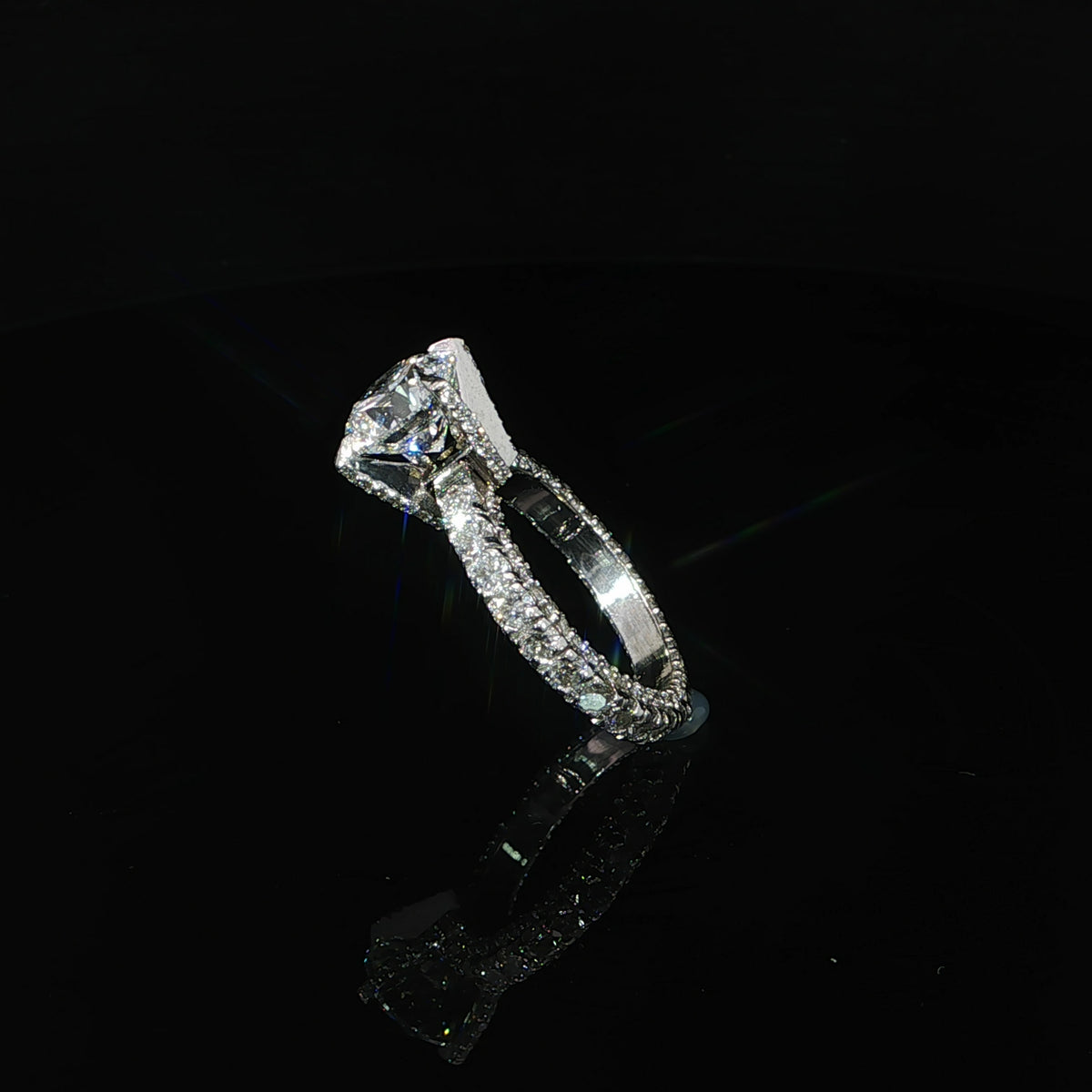Angled view of a round diamond ring showing the gallery and diamond-set band