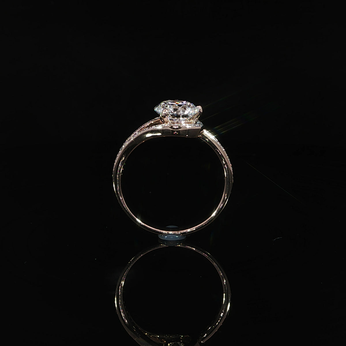 Round lab grown diamond engagement ring featuring a flowing bypass setting in polished 14K rose gold.