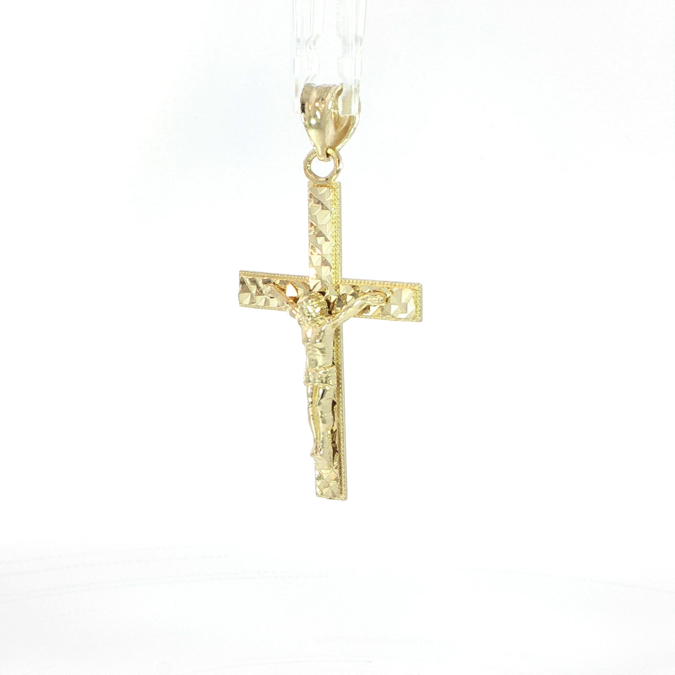 Traditional yellow gold Jesus crucifix pendant with textured detailing.
