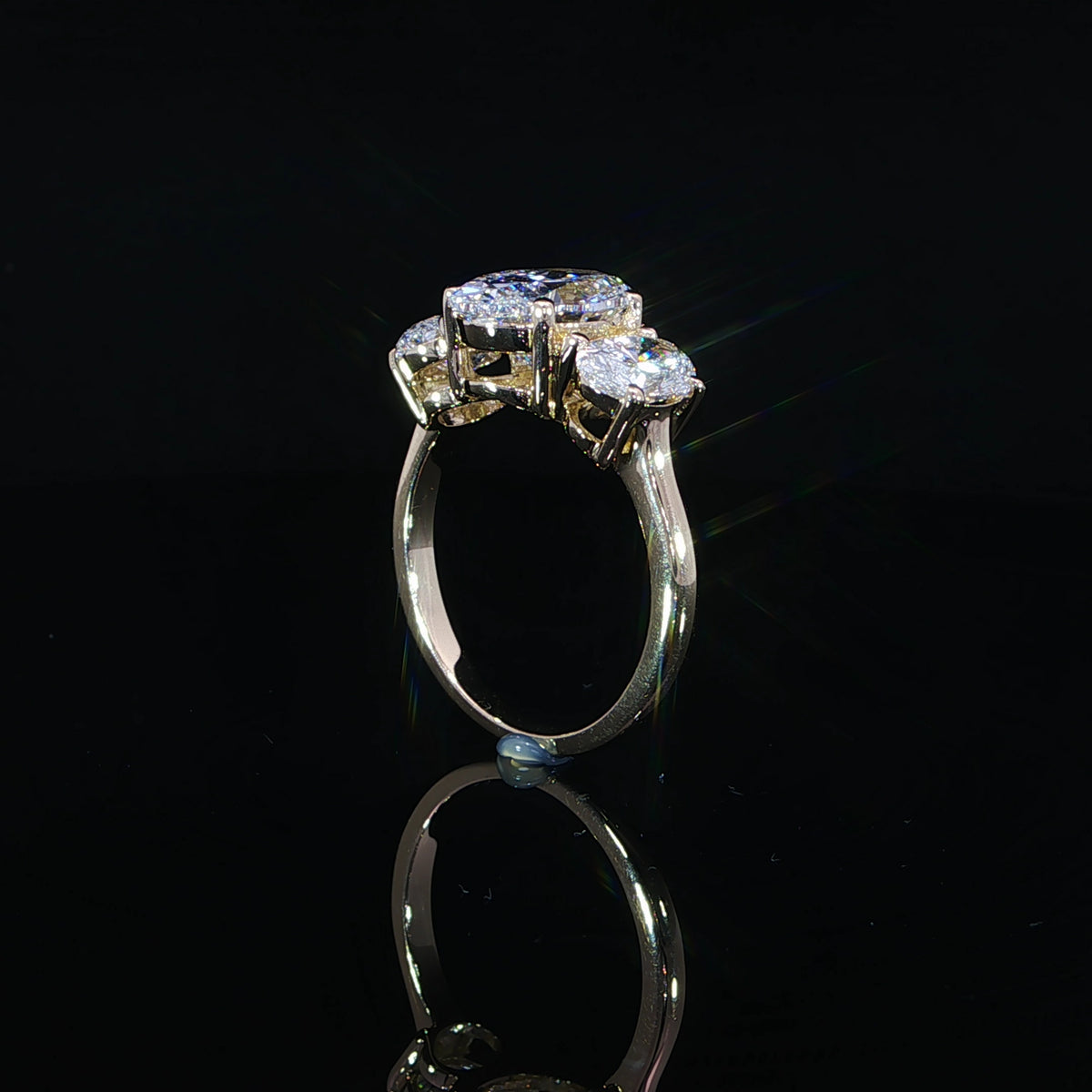 Standing profile of a lab-grown diamond ring with the larger center above a smaller side stone.
