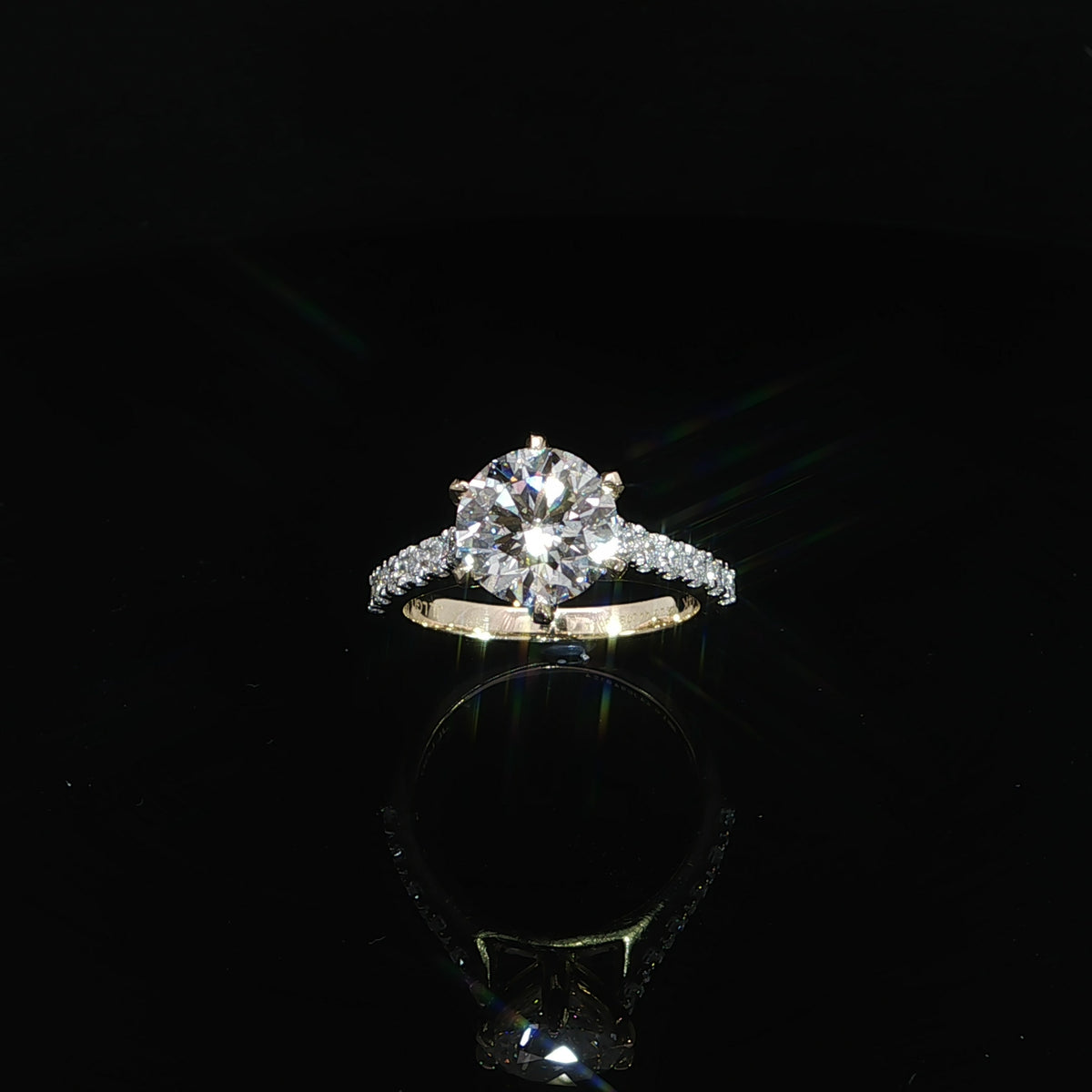 Top view 3 CTW lab grown diamond engagement ring with a 2.54 carat round center stone in 14K yellow gold.