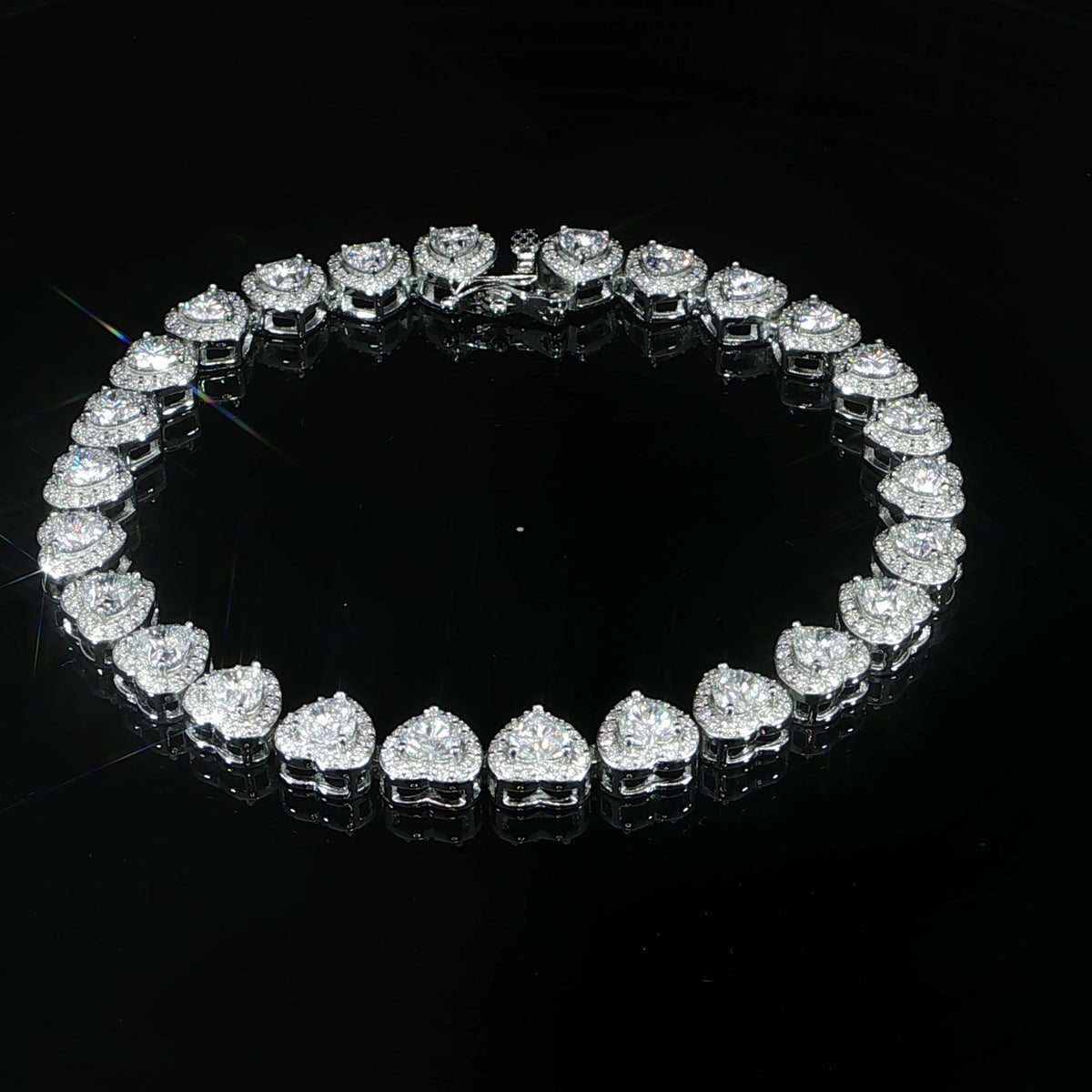 Top view of a VVS moissanite heart halo tennis bracelet in 925 sterling silver