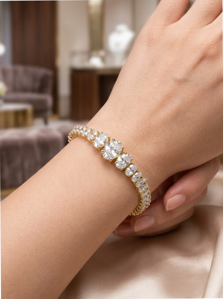 Close-up of model wearing VVS oval-cut moissanite stones in a graduated tennis bracelet