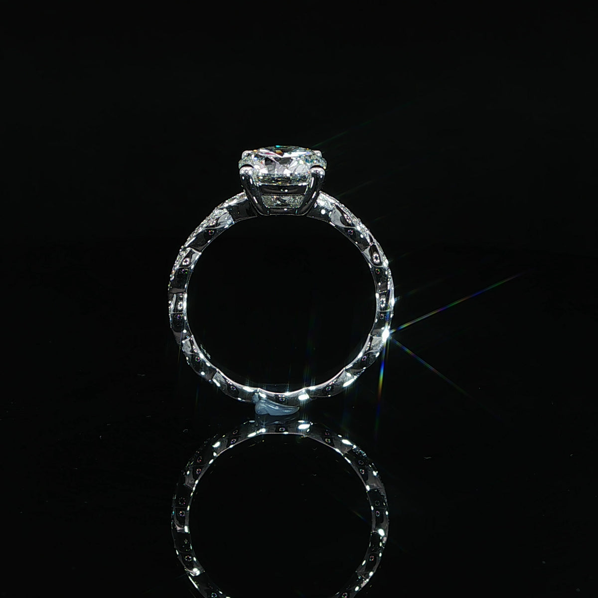 Close-up of the crossing diamond-set strands that form the band’s repeating twist pattern