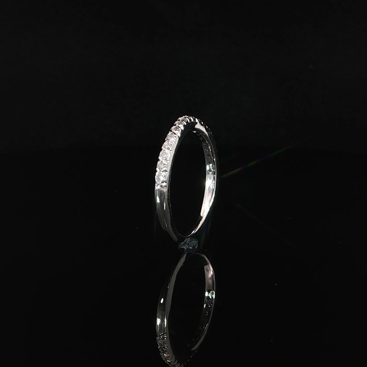 Side profile of a 14K white gold diamond nesting band showing its slender shank and gently curved diamond-set upper section.