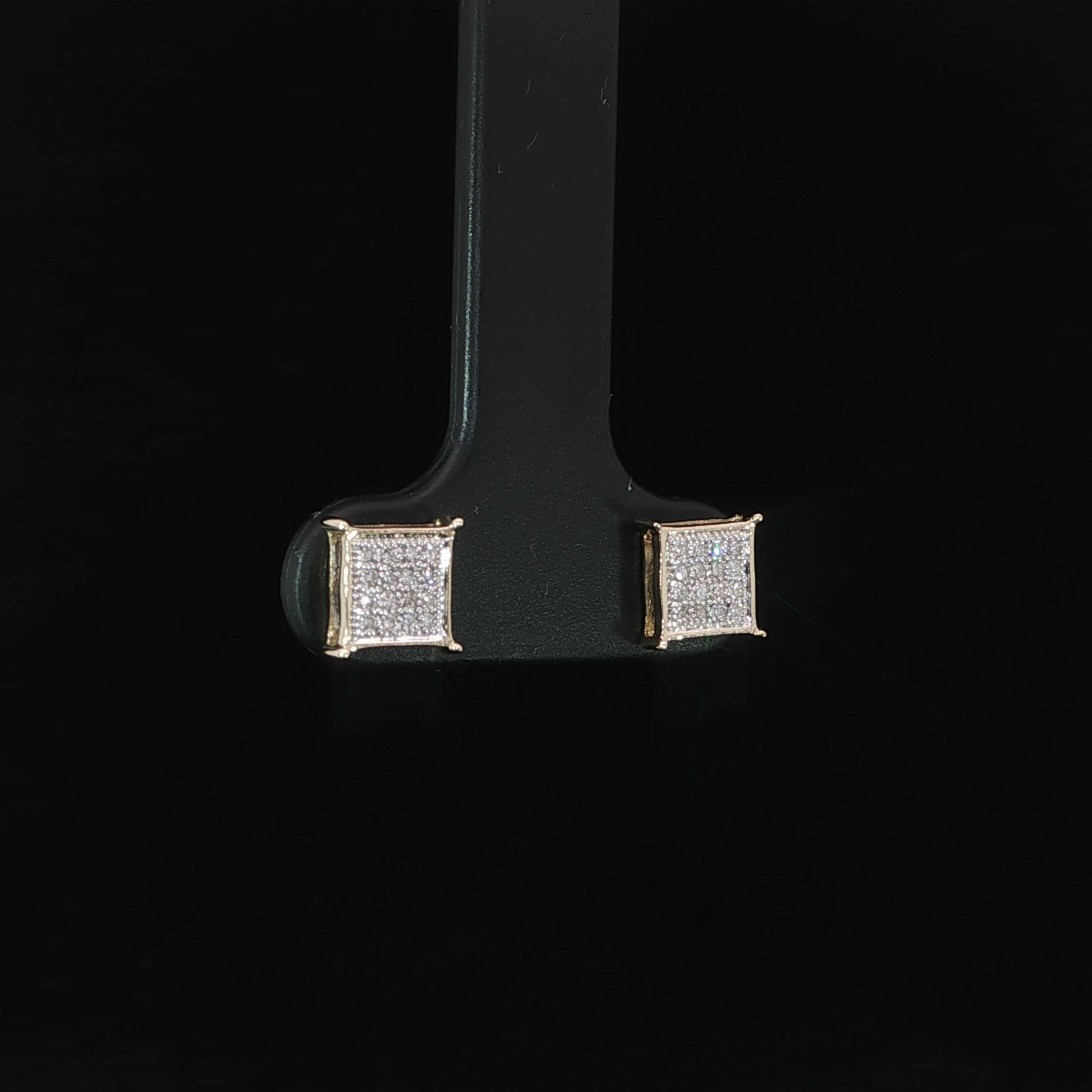 Angled view of yellow gold natural diamond square cluster studs